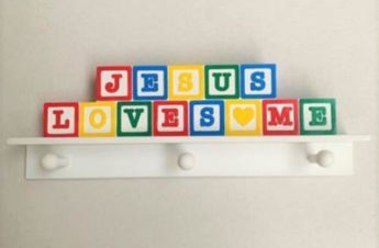 Picture of Jesus Loves Me. Bright coat hooks